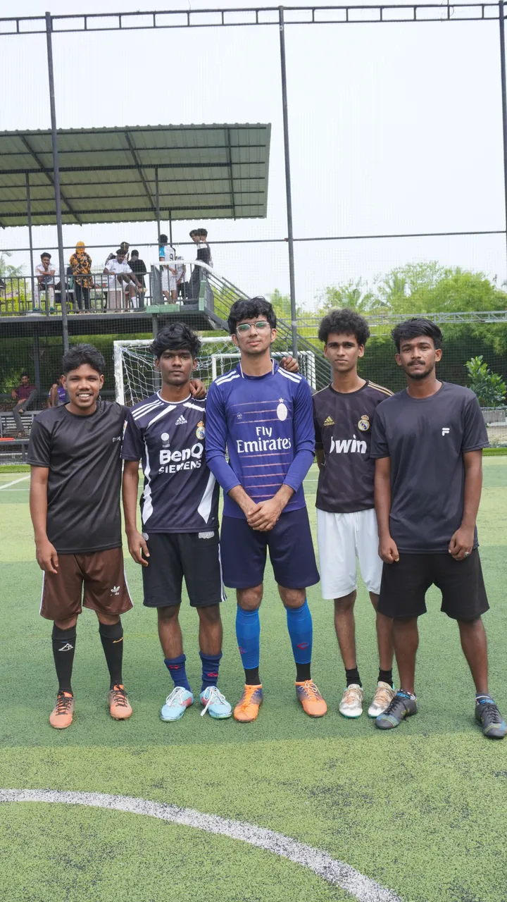 An OZO football team posing on the turf