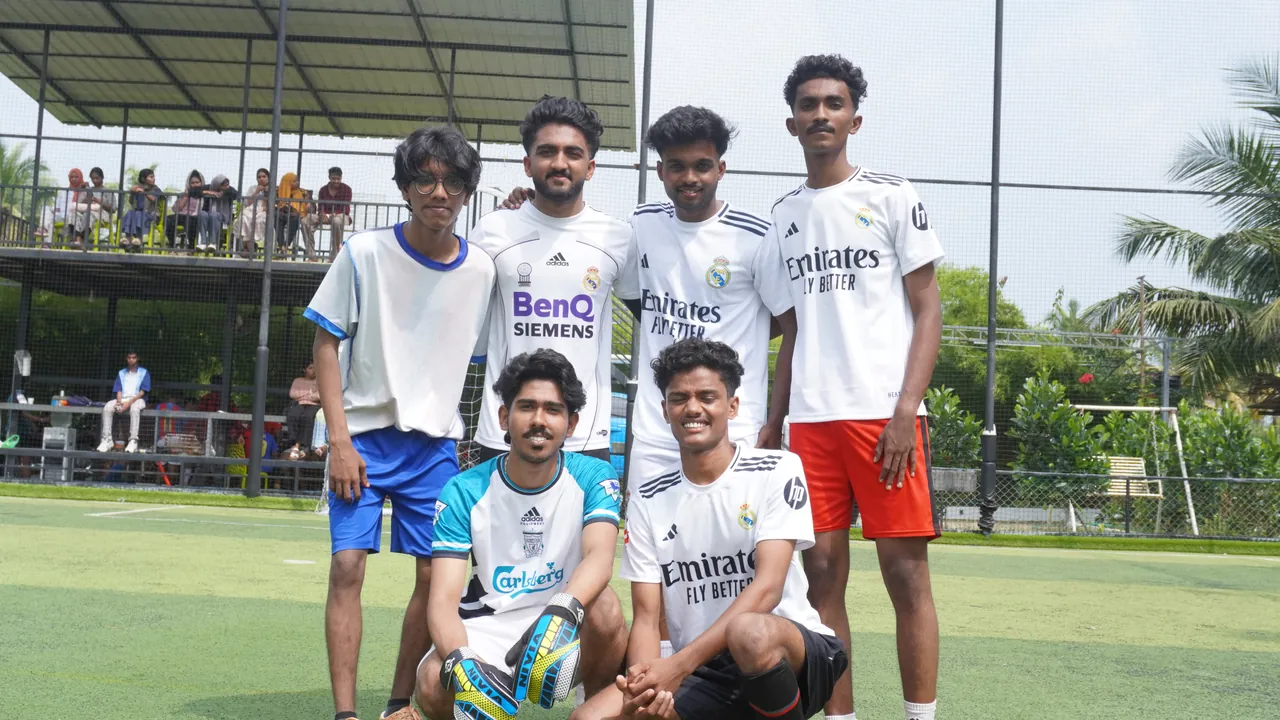 An OZO football team posing on the turf