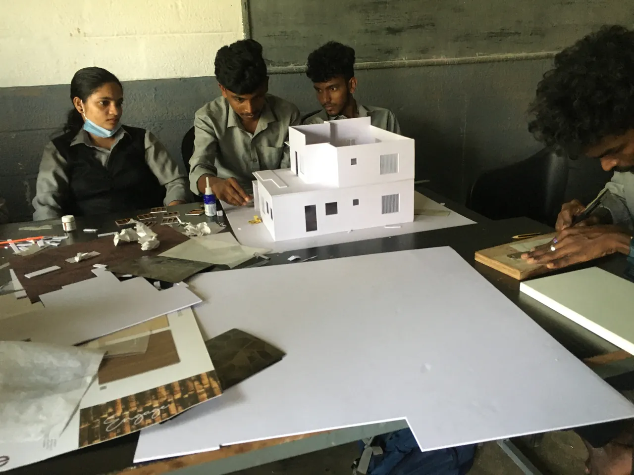 Interior design students building a scale model of a house
