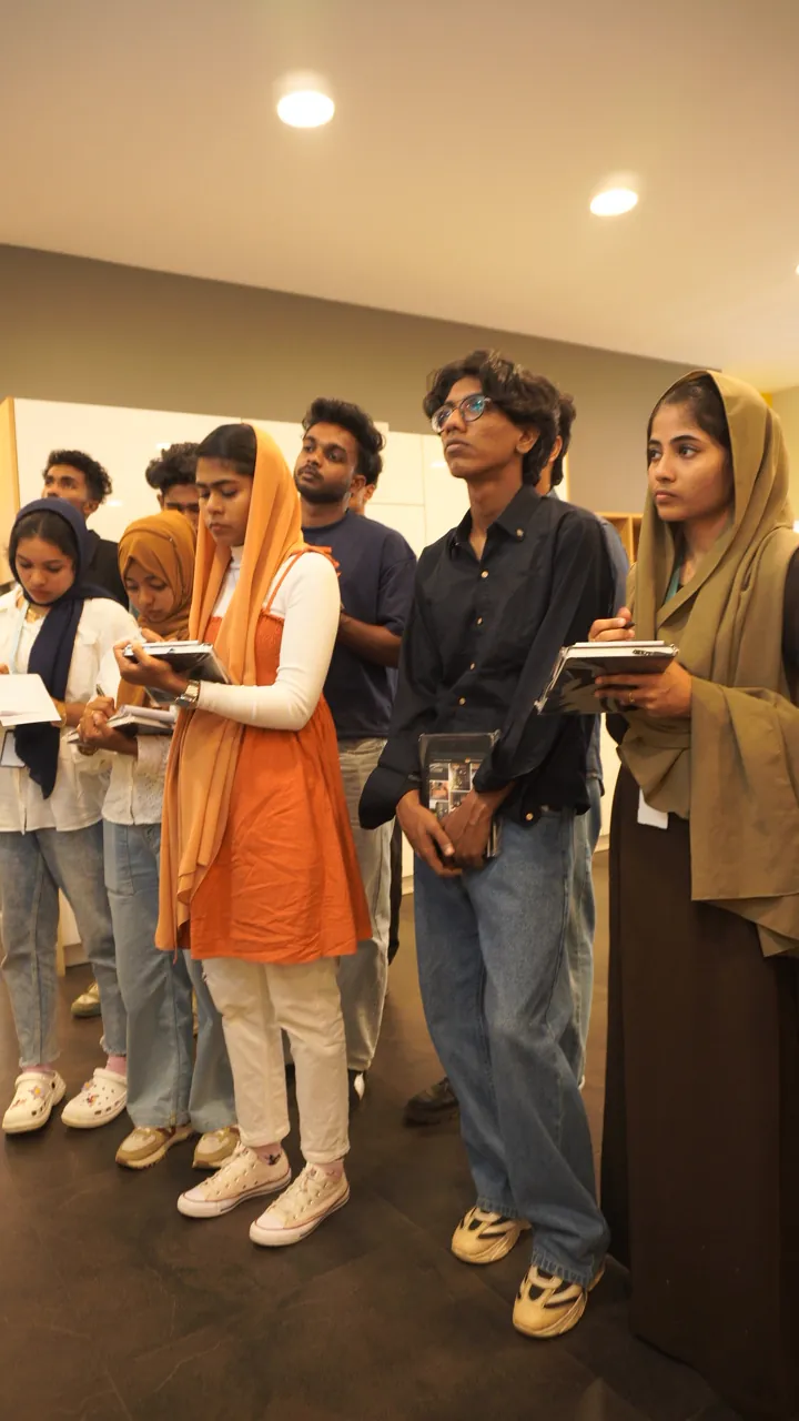 Students taking notes during a studio visit